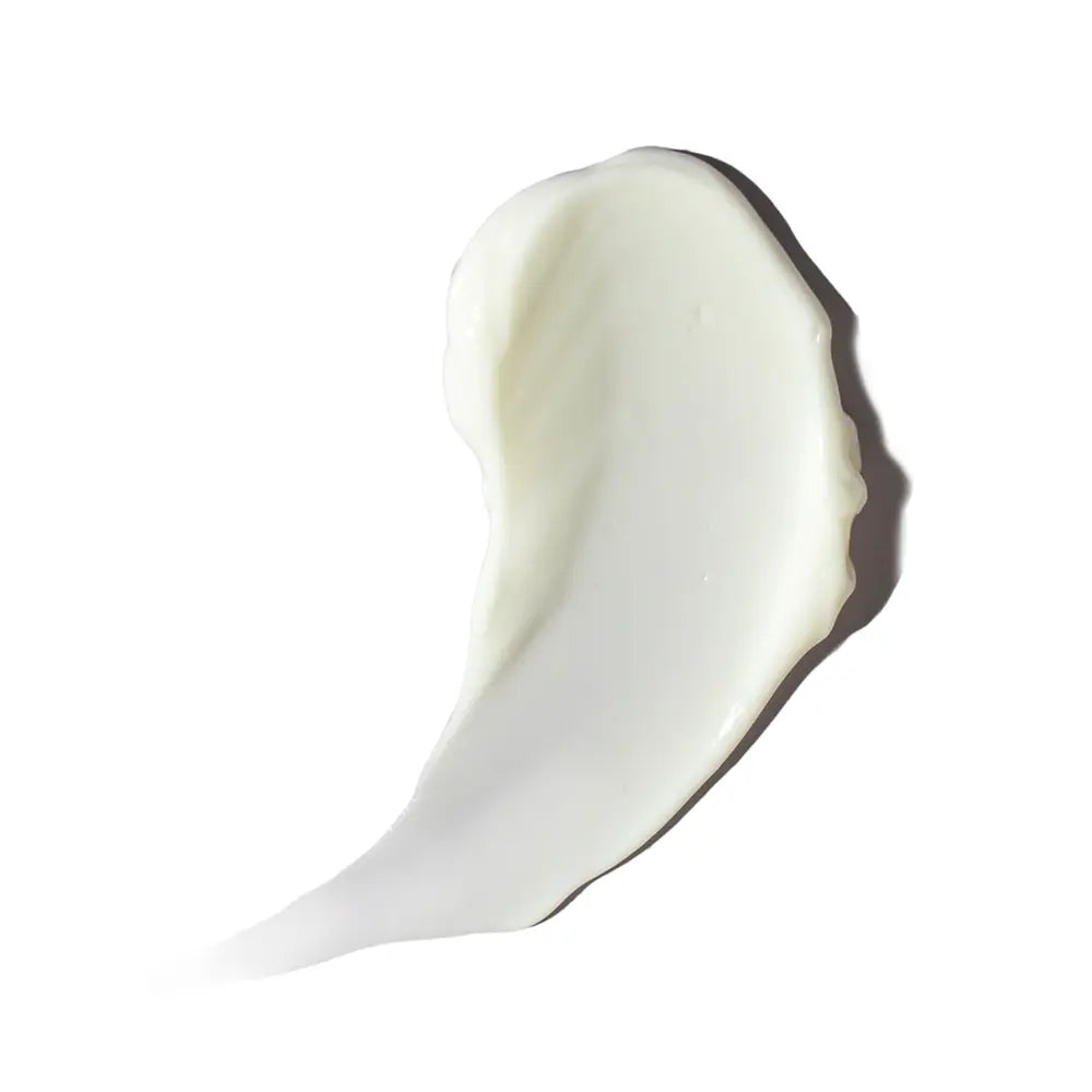 A thick, creamy white Alastin Ultra Calm Cleansing Cream smear, likely a lotion or cream, shown on a solid white background with a soft shadow.