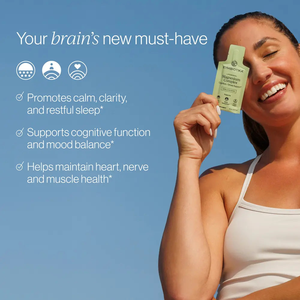 A smiling woman in a white tank top holds up a small green tea supplement packet against a clear blue sky. Text on the left reads 'Your brain's new must-have' with three benefit bullet points and three icons.