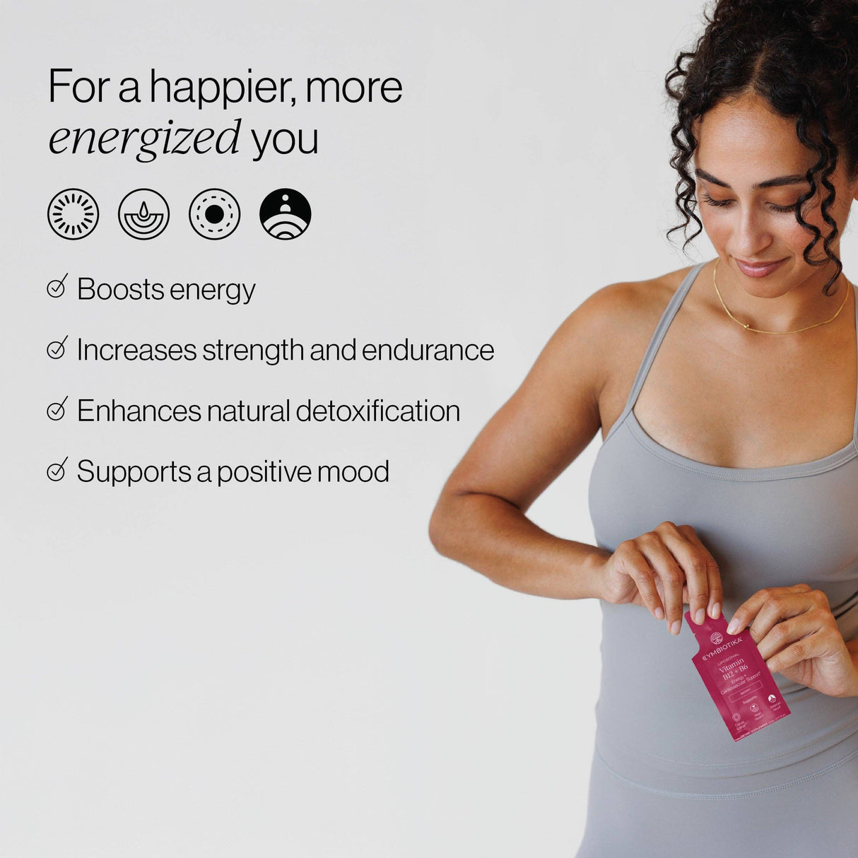 Woman holding a supplement package of Cymbiotika Vitamin B12 and B6 with its benefits on a light gray background