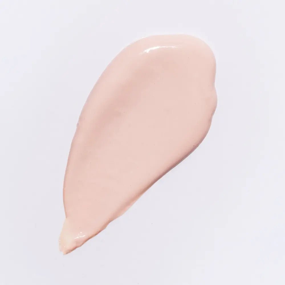 Beige cosmetic cream swatch on a light gray background