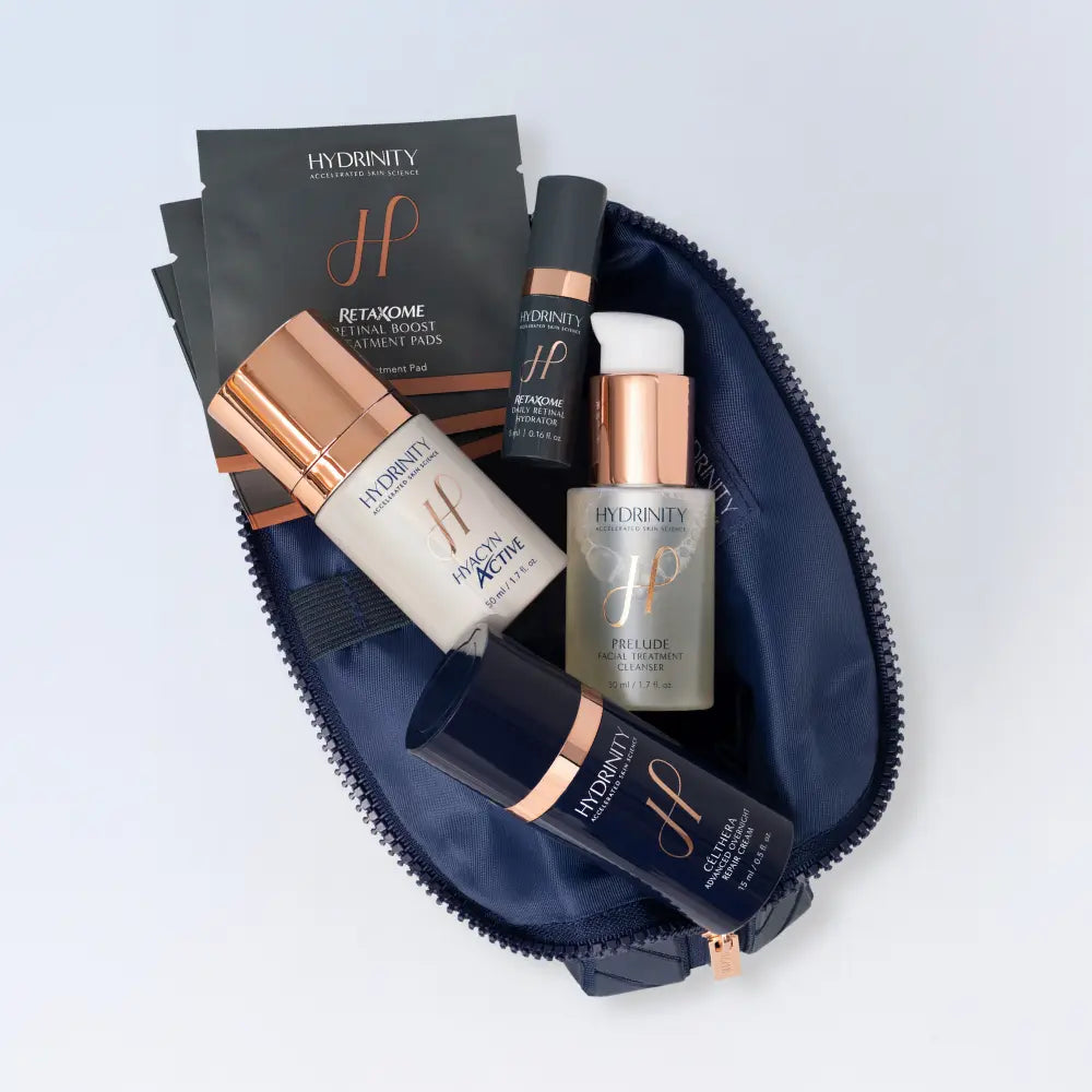 Hydrinity Wrapped in Radiance Set products arranged inside the open navy cosmetic bag