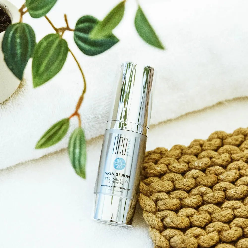 Neocutis skin serum bottle on a textured surface with green leaves in the background