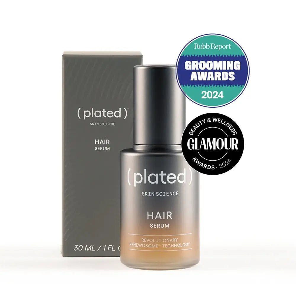Plated hair serum bottle and packaging with awards on a white background