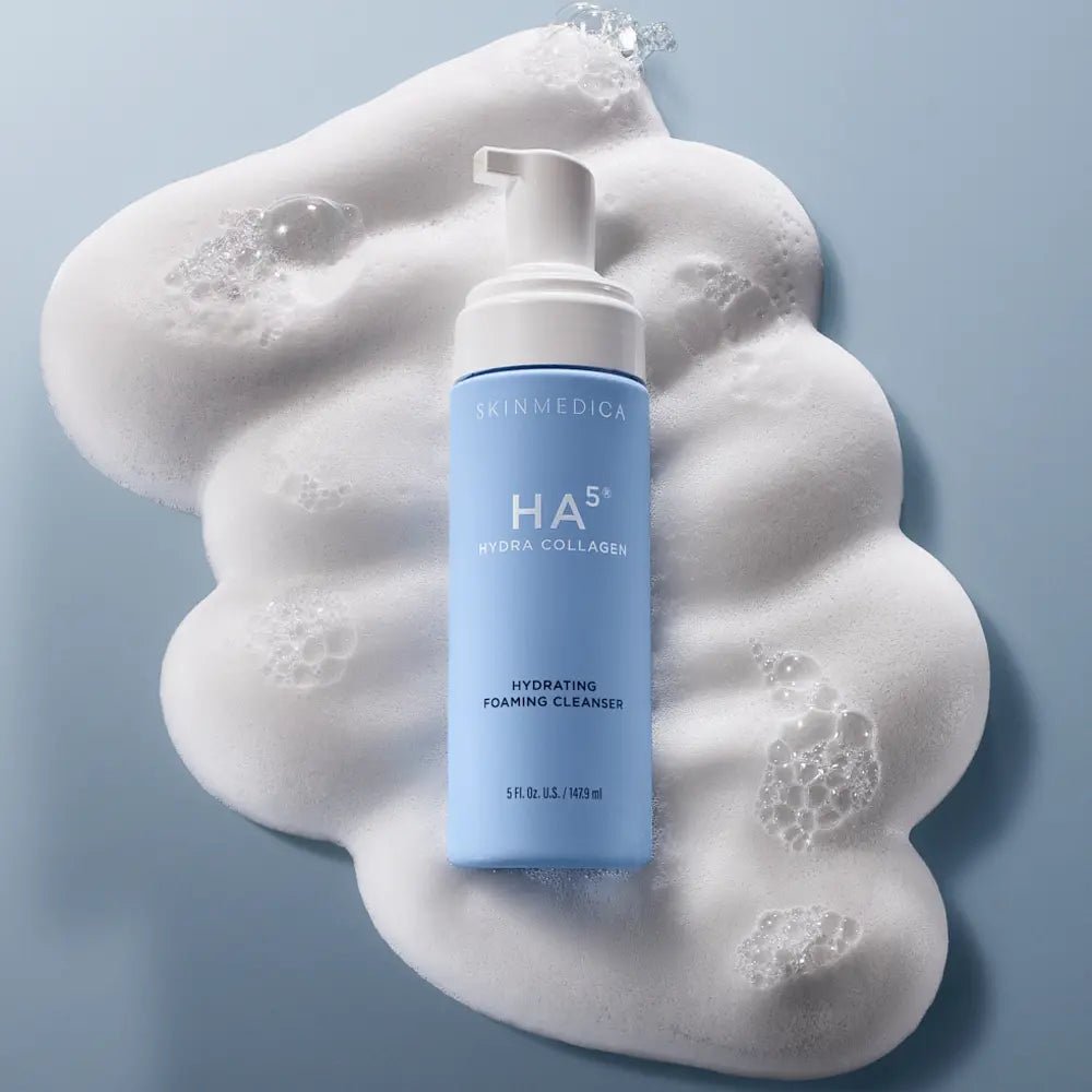 Blue bottle of HA5 Hydra Collagen Hydrating Foaming Cleanser with foam behind it