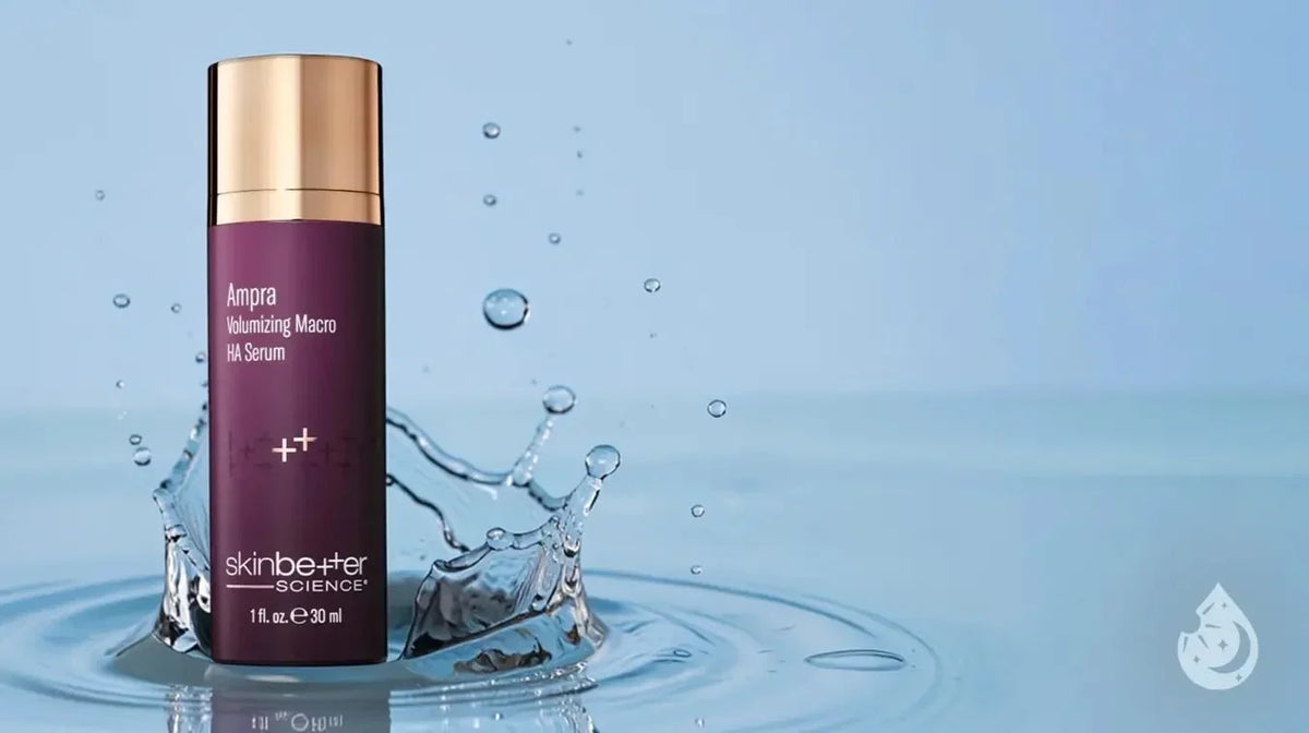 Bottle of Skinbetter Science Amprio Volumizing Macro HA Serum sitting in splashing blue water