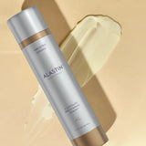 Alastin skincare A-Luminate serum bottle on a beige background