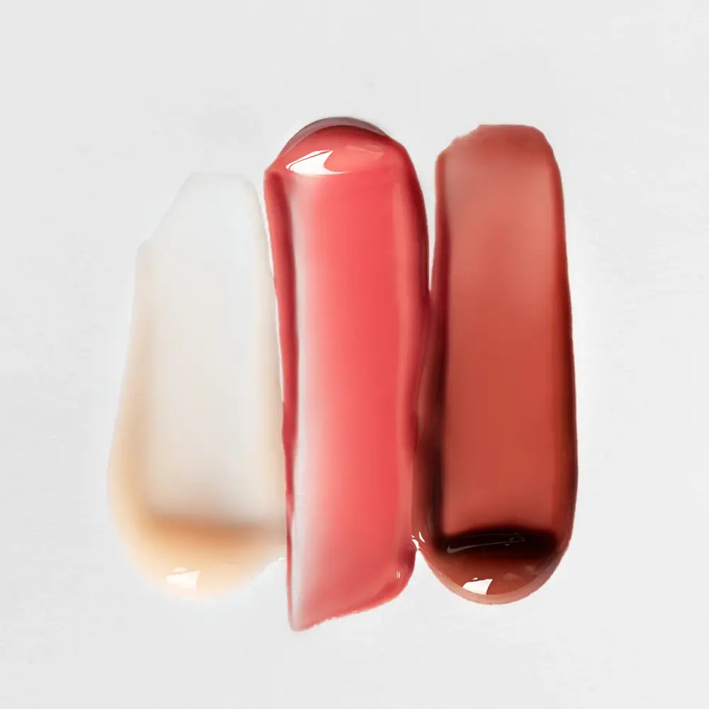 3 Anfisa lip glosses in different shades on a light gray background