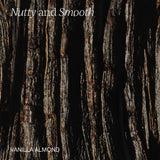 A close-up texture shot of dark vanilla almond bark with vertical grooves and glossy highlights, with the text 'Nutty and Smooth' at the top and 'VANILLA ALMOND' at the bottom in white.