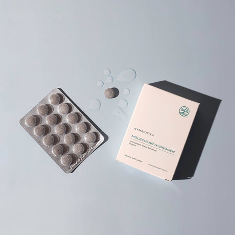 Packaging of Cymbiotika Molecular Hydrogen tablets on a gray background