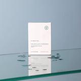 Cynsiotika Molecular Hydrogen skincare product packaging on a reflective surface with a gradient blue background