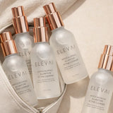 Several bottles of Elevai HOCl Allantoin Active Cleanser Spray in a travel makeup bag