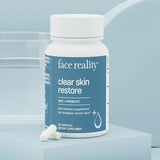 Supplement bottle labeled 'face reality clear skin restore' on a light blue background