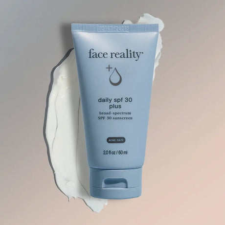 Tube of 'face reality' daily SPF 30 plus sunscreen on a gradient background
