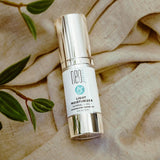 Neogenesis Light Moisturizer botle on fabric background - Your Skincare Source