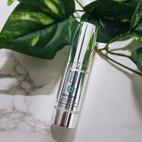 NeoGenesis Recovery serum bottle with green leaves in the background