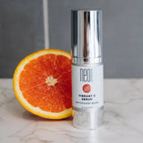 Neogenesis Vibrant C Serum Antioxidant Boost for all skin types next to an orange - Your Skincare Source