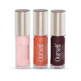 Three lip balm tubes with 'Ourself' branding on a white background