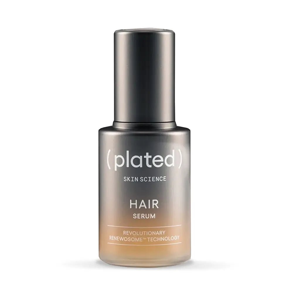 Plated hair serum bottle on a white background