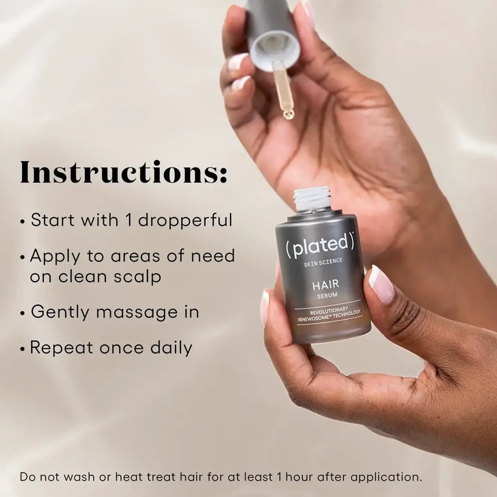 Hand holding a bottle of plated hair serum with application instructions.