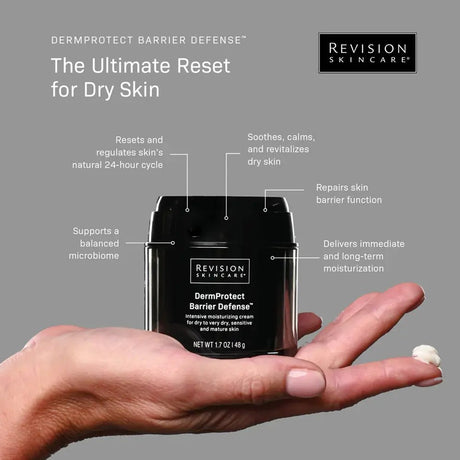 Revision Skincare DermProtect Barrier Defense cream with hand holding it on a gray background