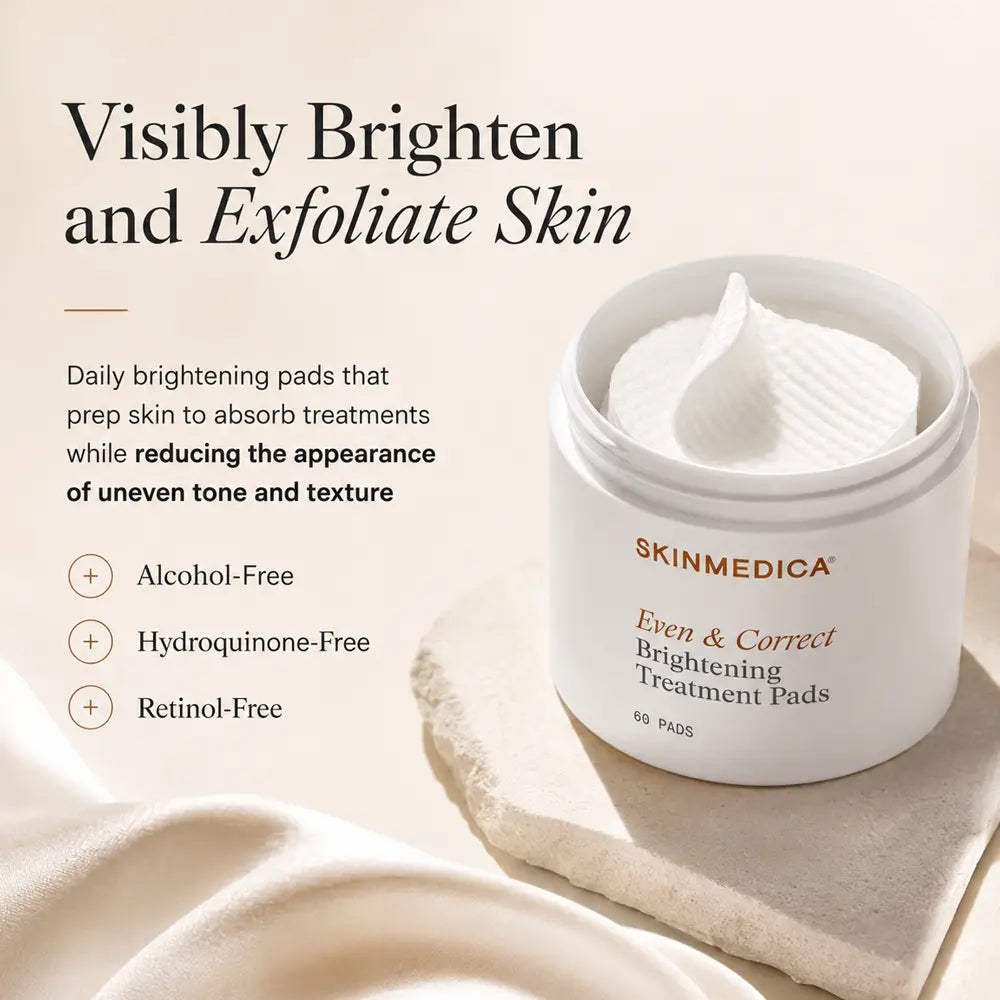 A white cosmetic jar of SkinMedica Even & Correct Brightening Treatment Pads sits on a beige stone slab with draped fabric. Text on the left reads 'Visibly Brighten and Exfoliate Skin' with product benefits listed below.