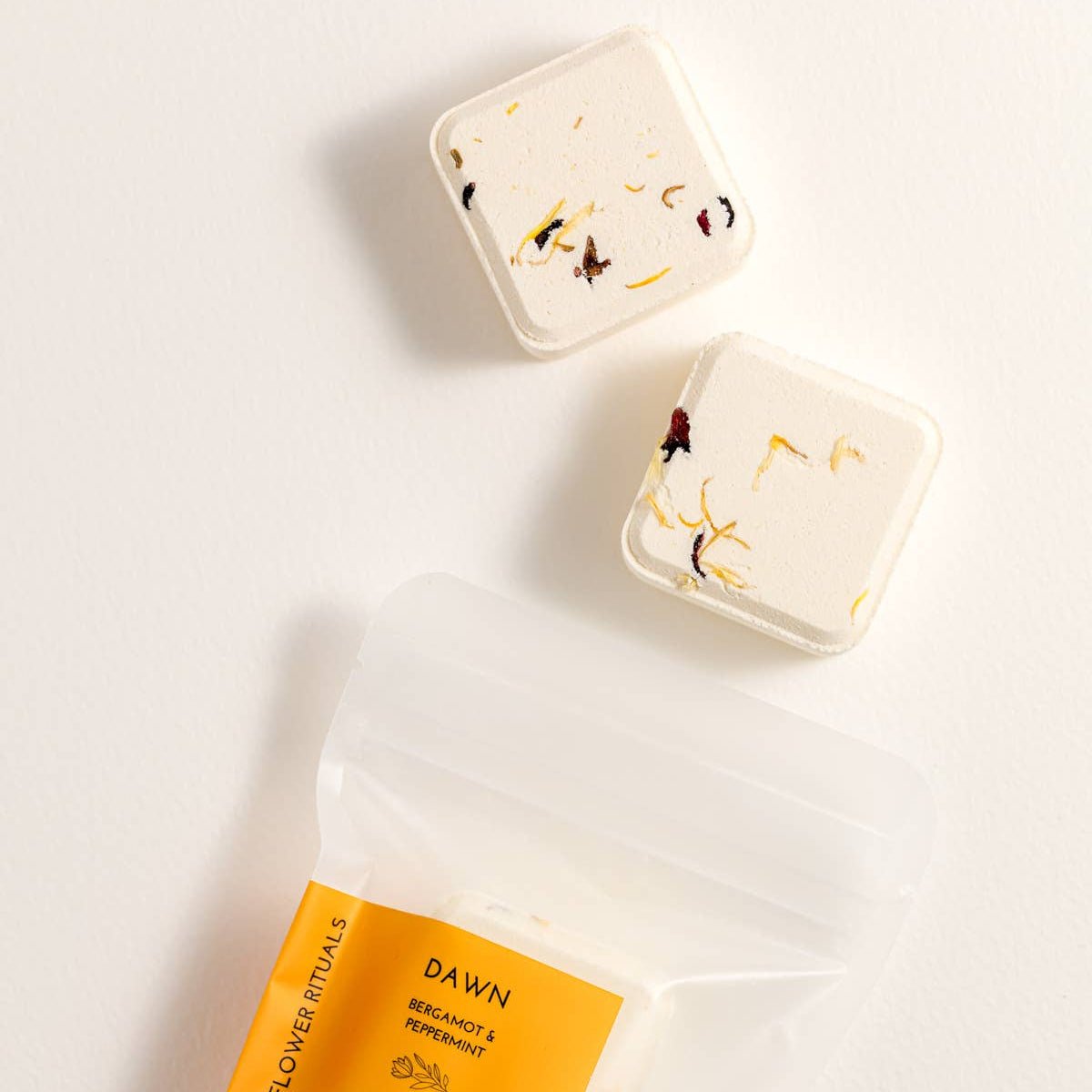 Two Dawn Shower Steamers with packaging on a light background