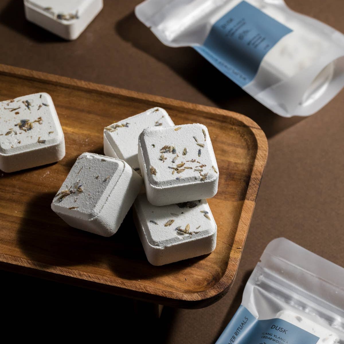 wildflower rituals dusk shower steamers on a wood tray