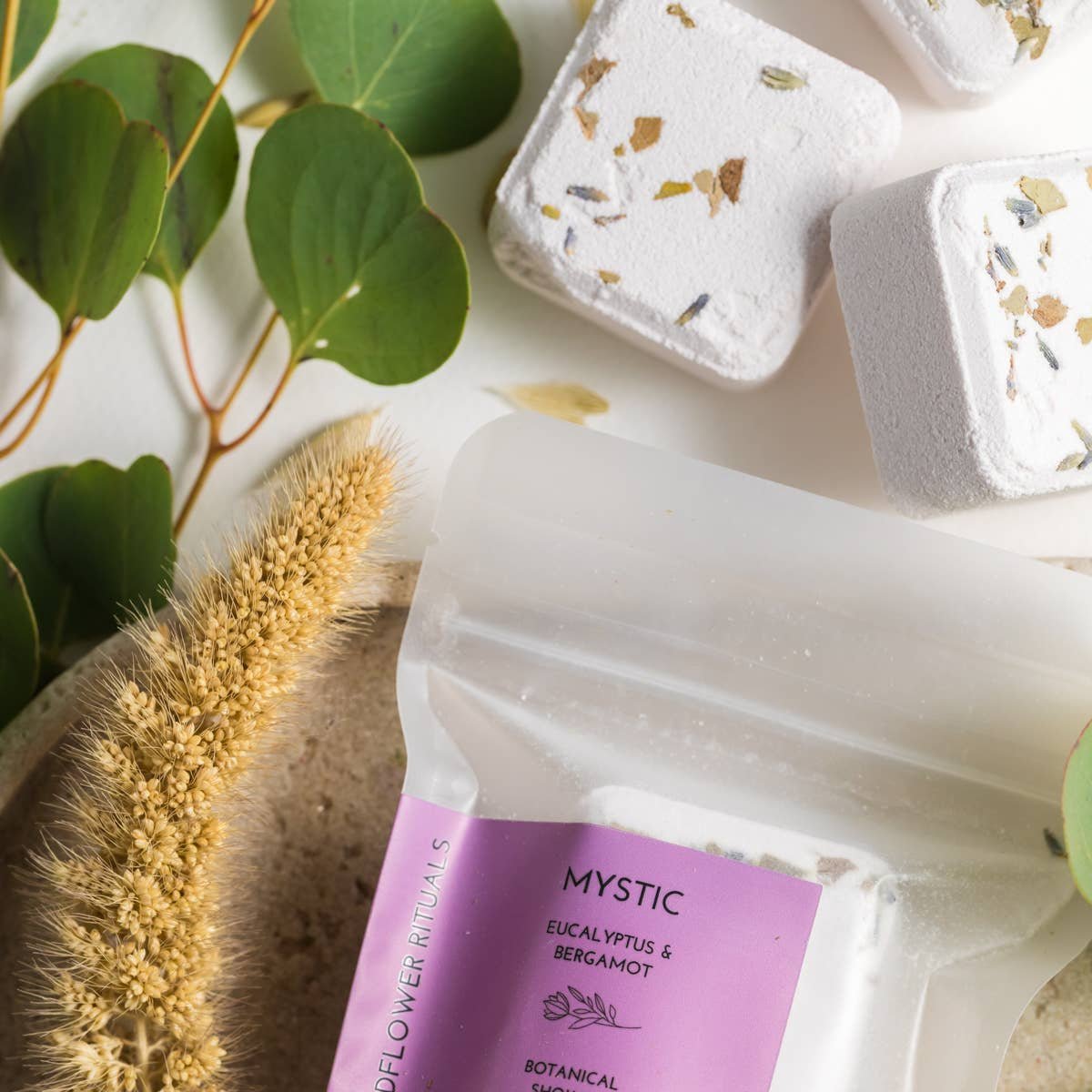 Mystic botanical bath bomb packaging with eucalyptus and lemon verbena on a natural background