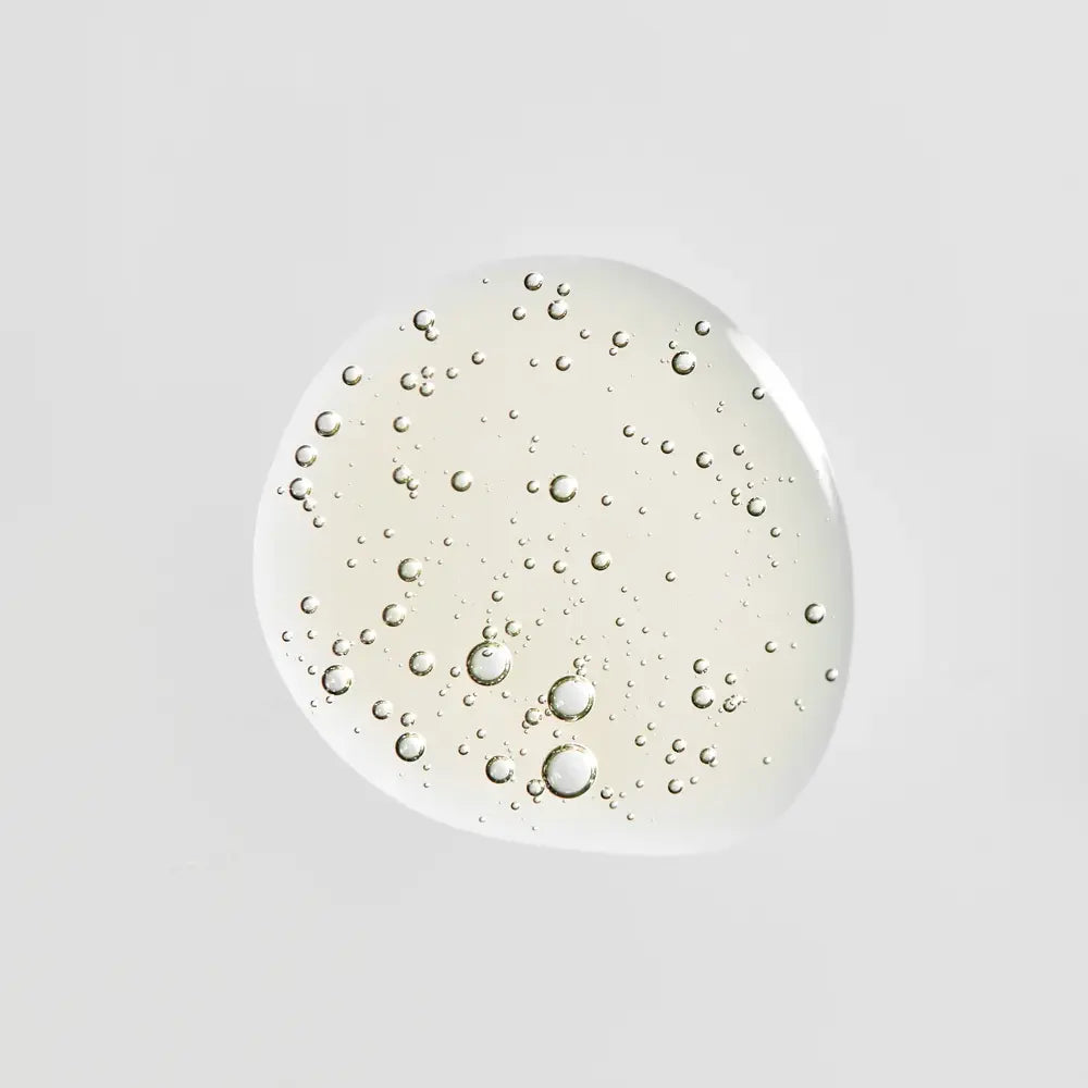A glossy, translucent droplet of Young Goose Bio-Retinol, centered on a solid light gray background.