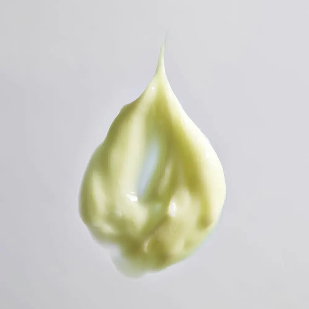 A dollop of Young Goose Youth Daily product texture on a light gray background.